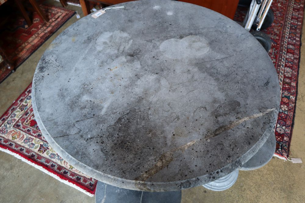 A circular reconstituted stone garden table, 100cm diameter, 80cm high and four matching stools,